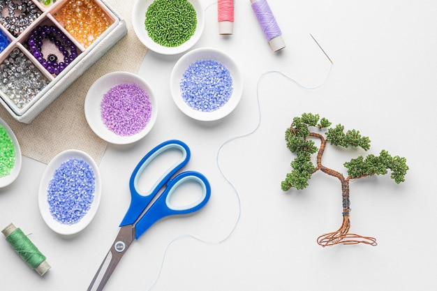 Top view of bead working essentials with scissors and tree