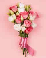 Free photo top view beautiful roses bouquet with pink ribbon