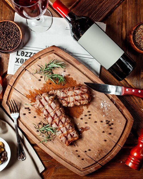 top view of beef steaks on wood platter