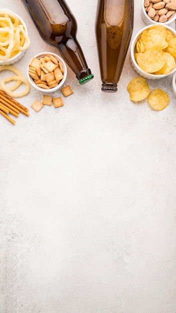 Top view beer bottles and snacks frame