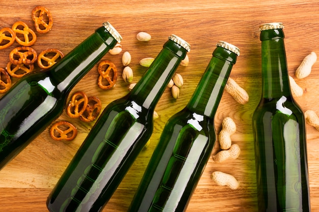 Free Photo top view beer bottles with snacks