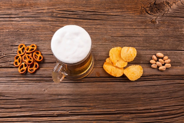 Free Photo top view beer mug with snacks