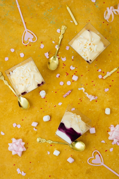 Top view of birthday cake with ribbon and marshmallow