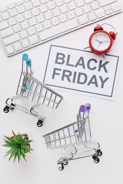 Free photo top view black friday shopping carts and keyboard