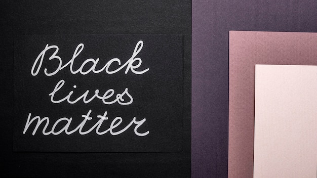 Free photo top view of black lives matter card on multicolored paper