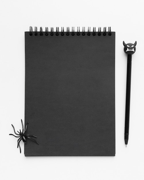 Free photo top view black notepad with spider on top