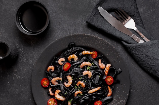 Free Photo top view black shrimp pasta with soy sauce and cutlery