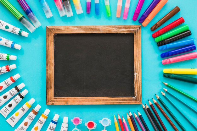 Top view blackboard surrounded by painting elements