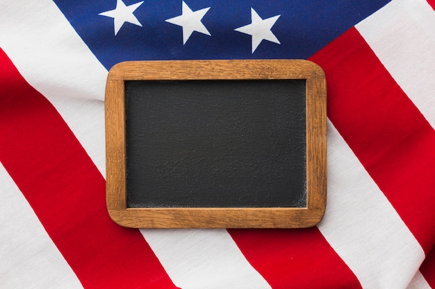 Free photo top view of blackboard on top of american flag