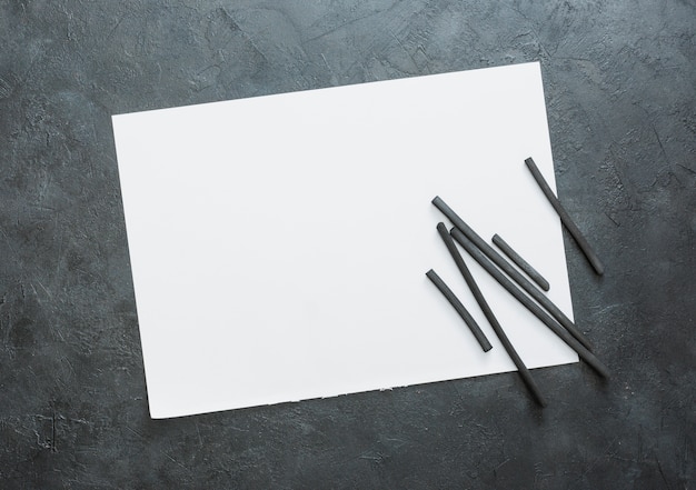 Free Photo top view of blank white sheet and natural hardwood charcoal stick