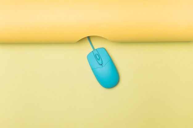 Free Photo top view blue computer mouse with yellow background