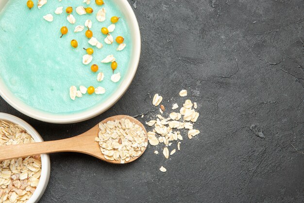 Top view blue iced dessert with raw muesli on dark table photo milk cereal