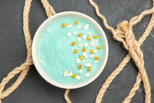 Top view blue iced dessert with ropes on dark table ice color cream 