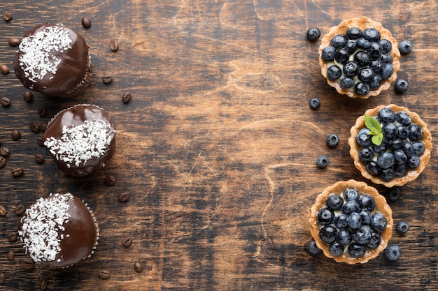 Top view of blueberry desserts with chocolate and copy space