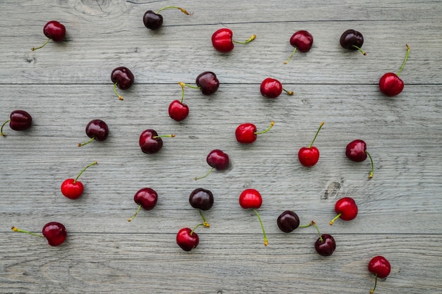 Free photo top view of boards with delicious cherries