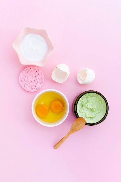 Free Photo top view of body butter and eggs on pink background