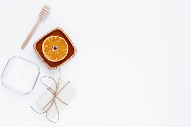 Top view of body butter and soap on white background