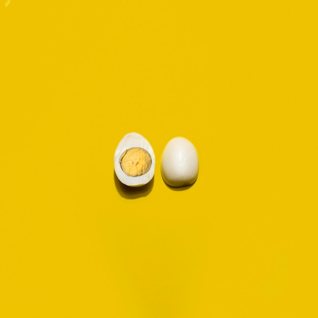 Top view boiled egg on yellow background