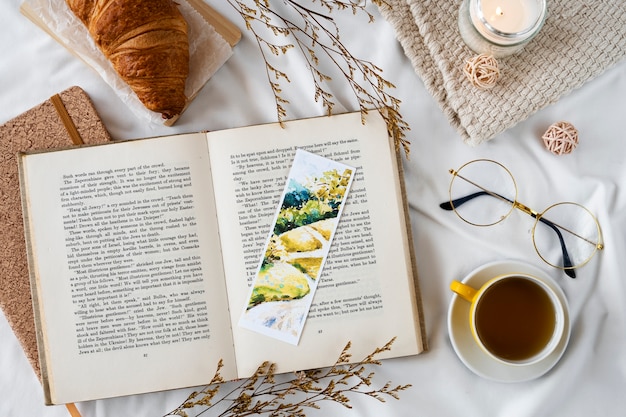 Free photo top view bookmark and tea cup arrangement