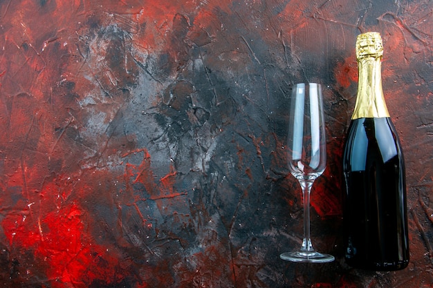 Top view bottle of champagne with glass on the dark alcohol color photo drink