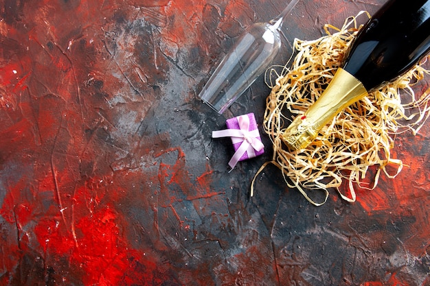 Top view bottle of champagne with wine glass on dark alcohol photo color