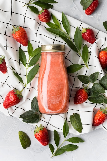 Free photo top view bottle with strawberry smoothie