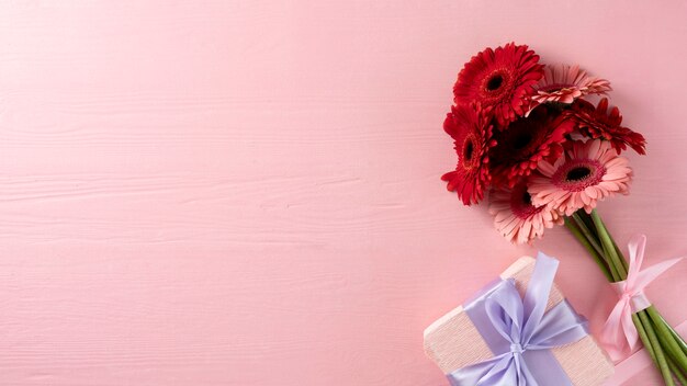 Top view of bouquet of flowers with gift box and copy space