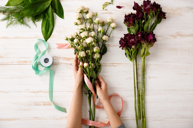 Free Photo top view bouquet of flowers on wooden table