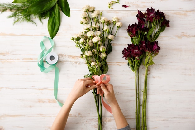 Free Photo top view bouquet of flowers on wooden table