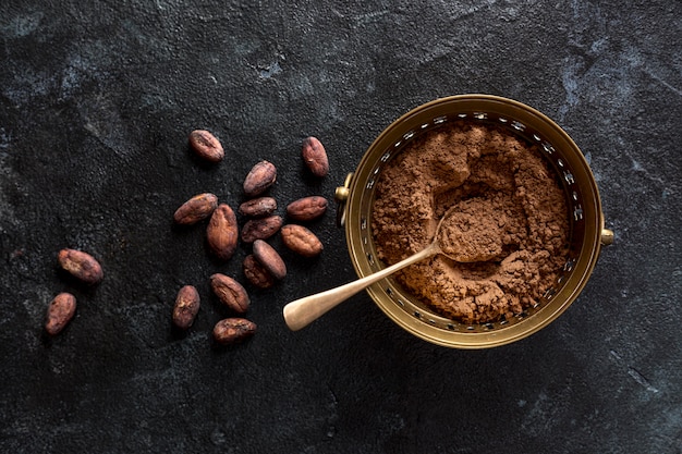 Free photo top view of bowl with cocoa powder and cocoa beans