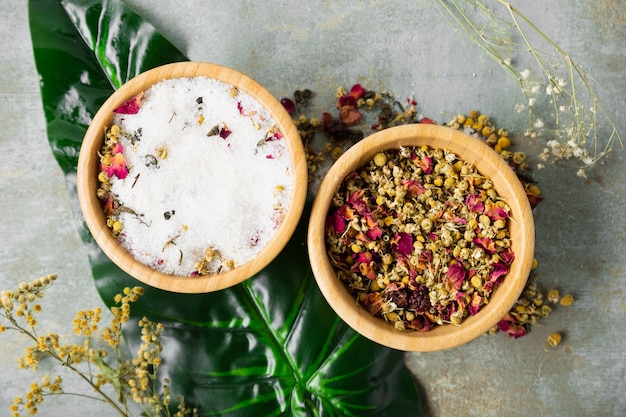 Free photo top view bowl with dry chamomile and mineral salt