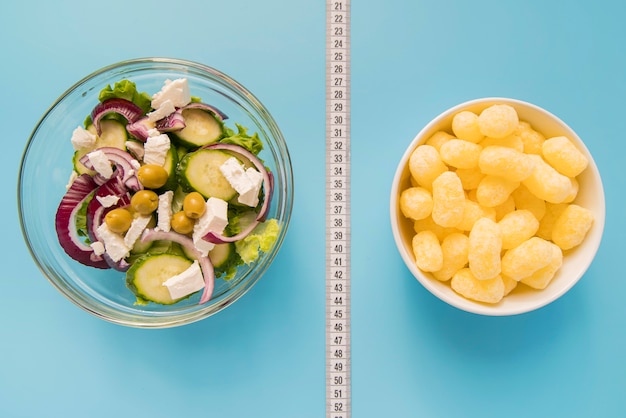 Free photo top view bowls with salad and puffs