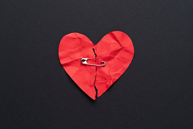 Top view broken heart with safety pin