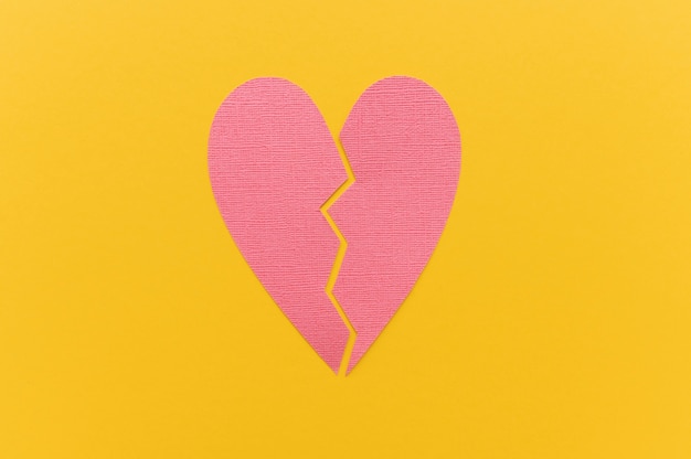 Top view of broken paper heart background