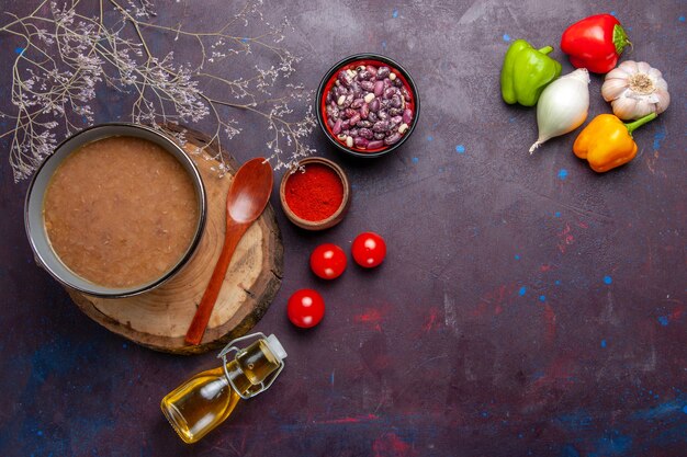 Top view brown bean soup with vegetables on dark surface soup vegetable meal kitchen bean