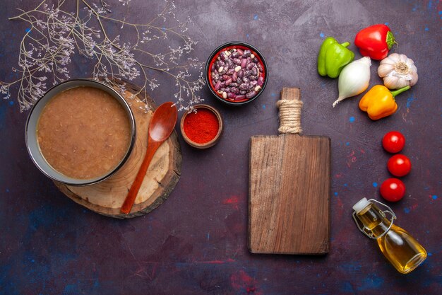 Top view brown bean soup with vegetables on a dark surface soup vegetables meal food kitchen bean