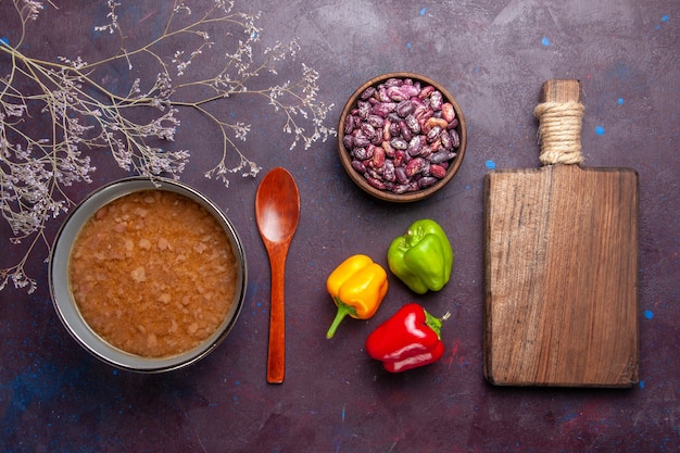 Free photo top view brown soup inside plate with beans on the dark surface soup vegetables meal food kitchen oil