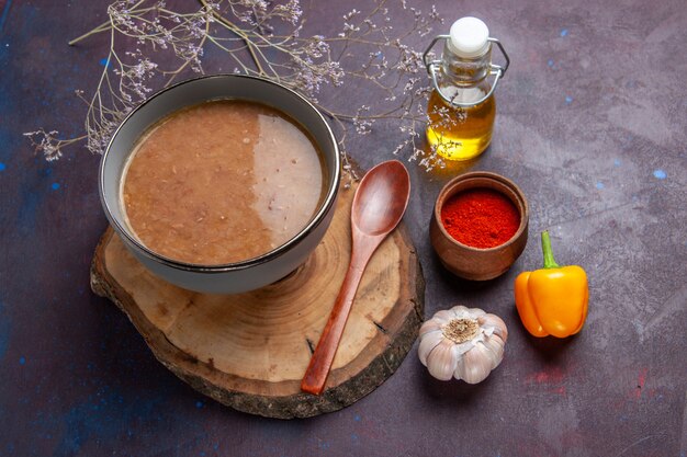 Top view brown soup with oil and garlic on dark surface soup vegetable meal food kitchen bean