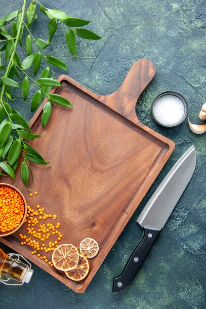 Top view brown wooden desk with big knife on a dark blue surface ancient cuisine food color meat butcher kitchen knife