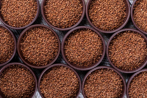 Top view buckwheats in bowls forming background. horizontal