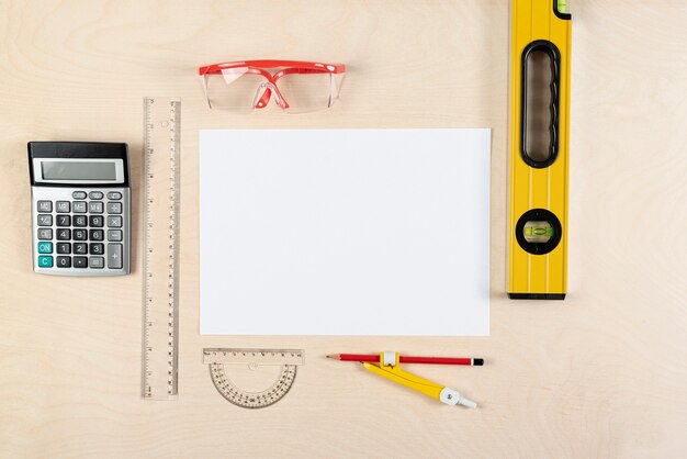 Top view of builder desk with blank paper sheet