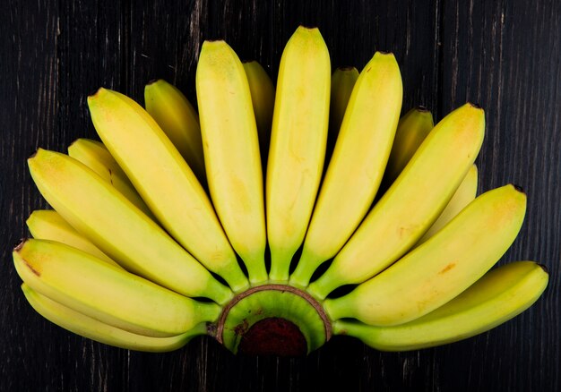 Top view of bunch of bananas isolated on black wood