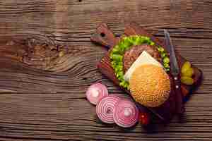 Free photo top view burger ingredients on wooden table