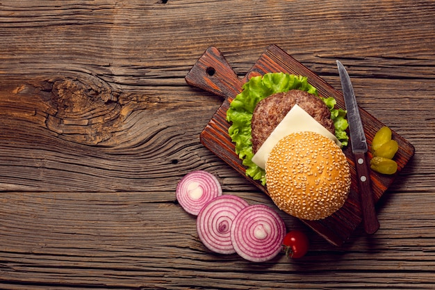 Free Photo top view burger ingredients on wooden table