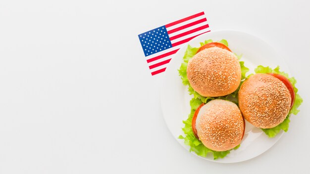 Top view of burgers on plate with copy space and american flag