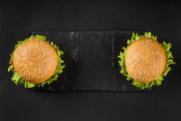 Free Photo top view burgers on slate board