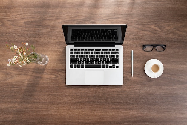 Top view business desk arrangement with laptop