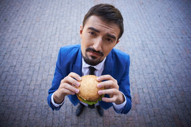 Top view of a businessman with a burger