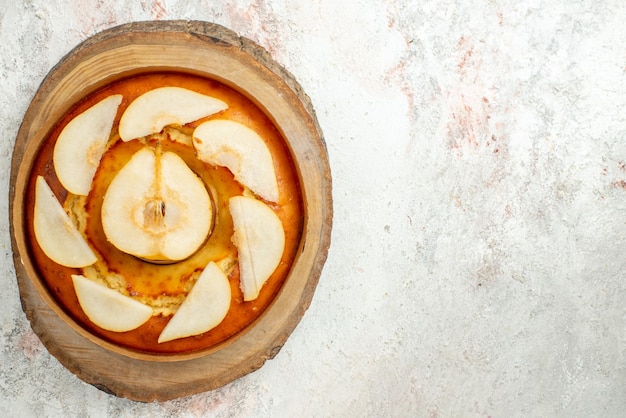 Top view cake appetizing pear cake on the wooden board on the left side of the light table