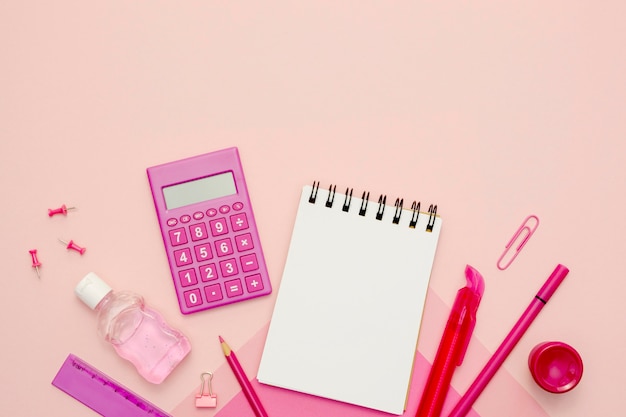 Top view calculator on pink background